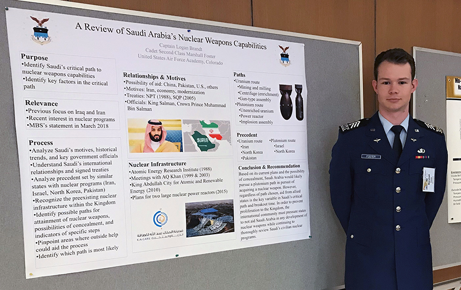 Marshall Foster standing next to his winning poster